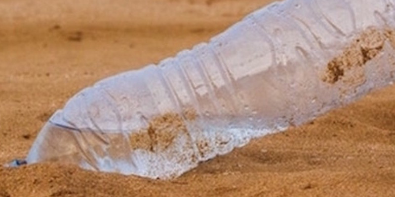 plastic polution on the beach by bottle